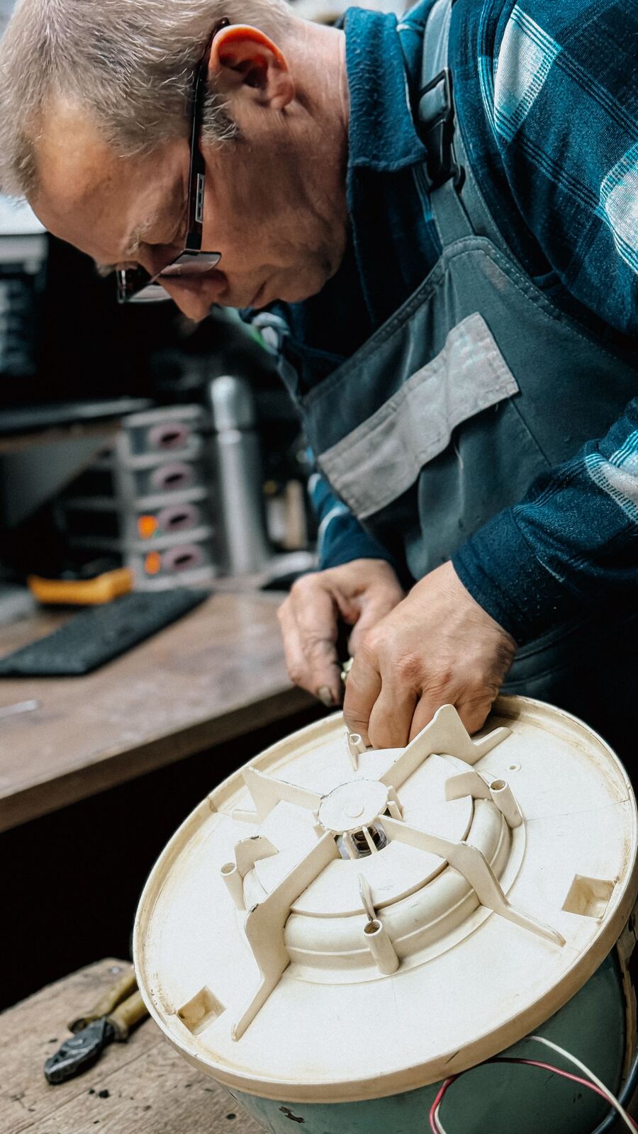 Technician reassembling the motor housing of a household appliance