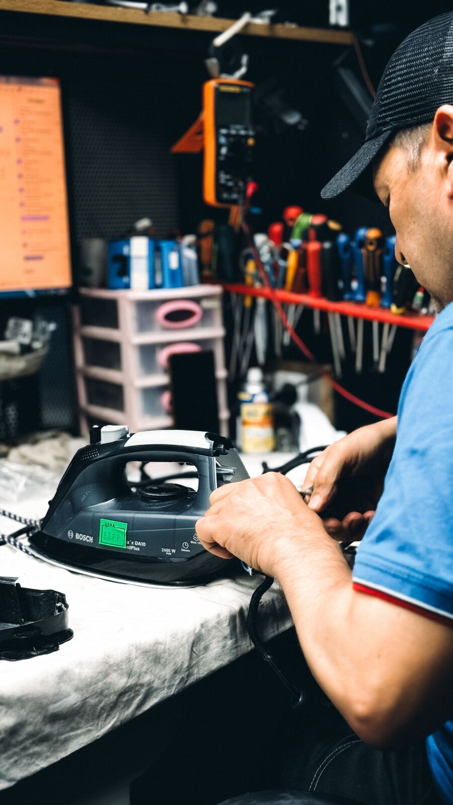 Technician working on the power cord of a steam iron